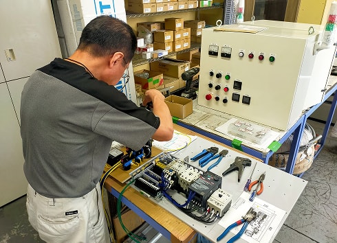 制御盤の配線作業を行う技術者
